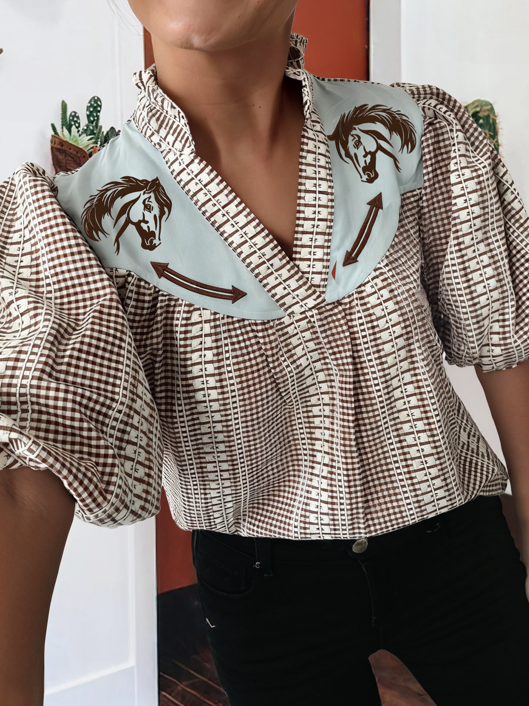 Person wearing a patterned blouse with horse design 